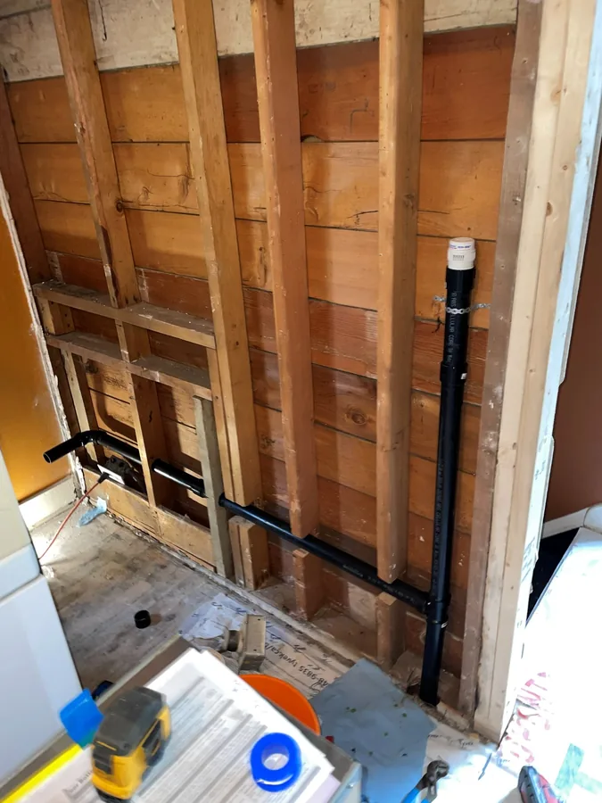 Drain and water lines roughed in through open studs