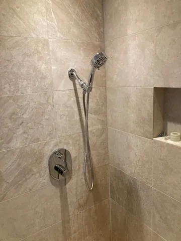 After: The finished tiled shower with its mixer and rail