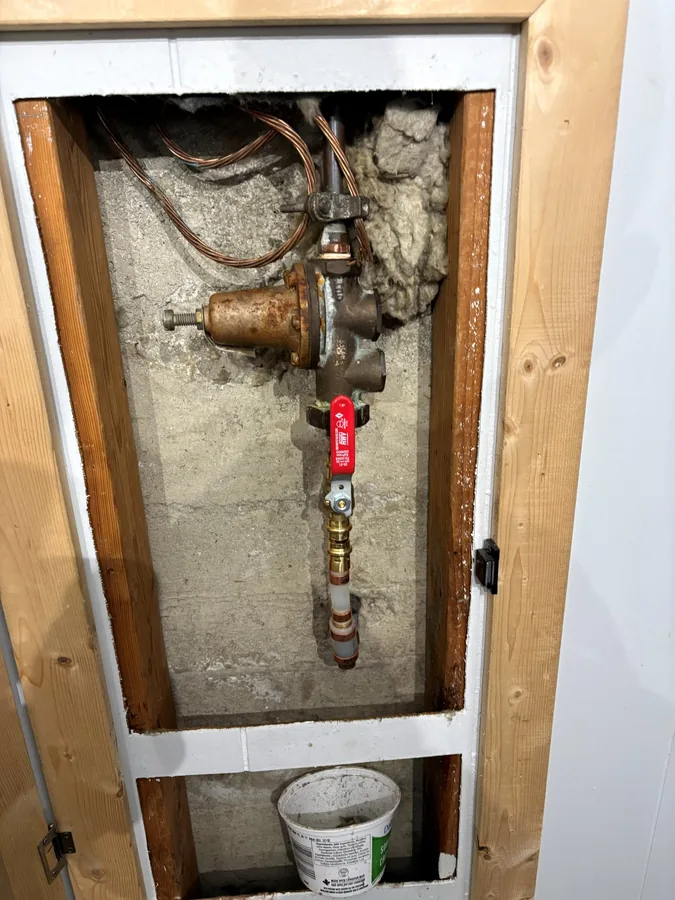 After: The new main shutoff valve fitted in the wall