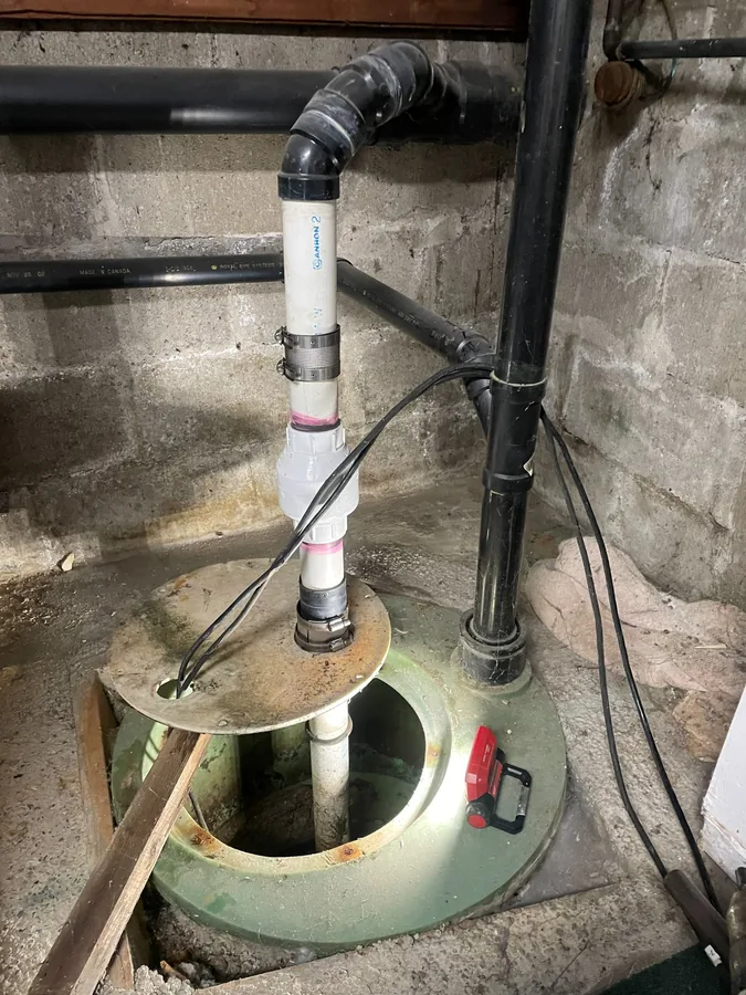 After: The new sump pump and pipework fitted in the pit